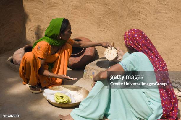 Two women making chapati.