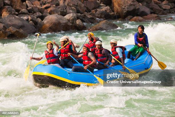 Group of people rafting in Ganges River, Rishikesh, Uttarakhand, India.