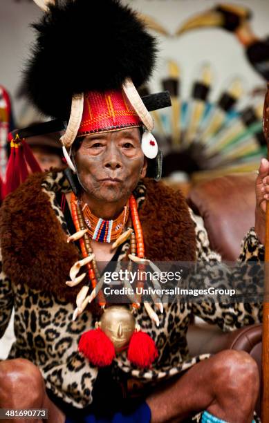 Elderly Naga tribesman in traditional outfit during the annual Hornbill Festival at Kisama, Kohima, Nagaland, India.