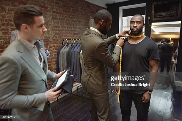 Portrait of New York Jets cornerback Darrelle Revis casual with fashion designers Aleks Musika and Davidson Petit-Frere in the Musika Frere store at...