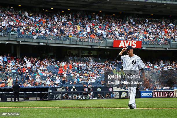 Masahiro Tanaka of the New York Yankees walks off the mound after being removed in the eighth inning against the Baltimore Orioles at Yankee Stadium...
