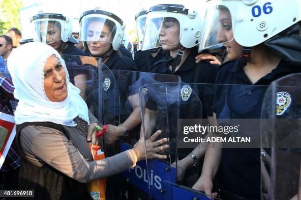 Members of the Peace Mothers face police officers during a protest against a suicide bombing, that killed 32 activists on July 20 in the Turkish...