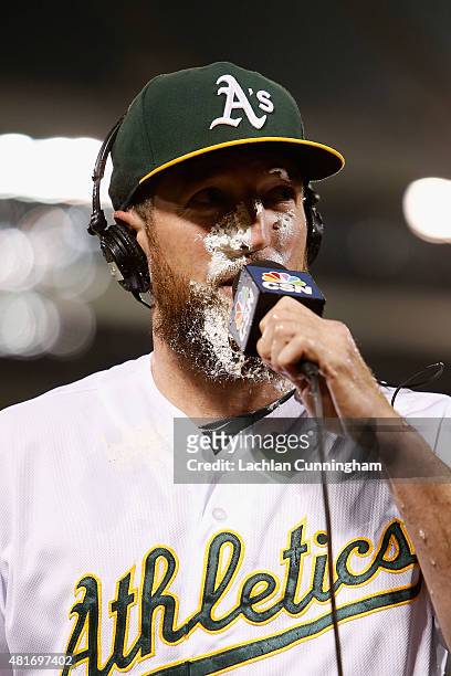 Ike Davis of the Oakland Athletics is hit in the face with whipped cream after he hit a walk-off RBI single in the tenth inning against the Toronto...