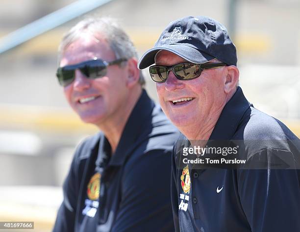 Former captain Bryan Robson and former manager Sir Alex Ferguson of Manchester United watch during a first team training session as part of their...