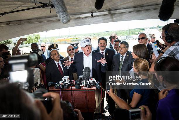 Republican Presidential candidate and business mogul Donald Trump talks to the media along the U.S. Mexico border during his trip to the border on...
