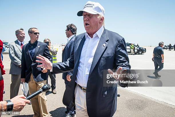 Republican Presidential candidate and business mogul Donald Trump talks to the media after exiting his plane during his trip to the border on July...