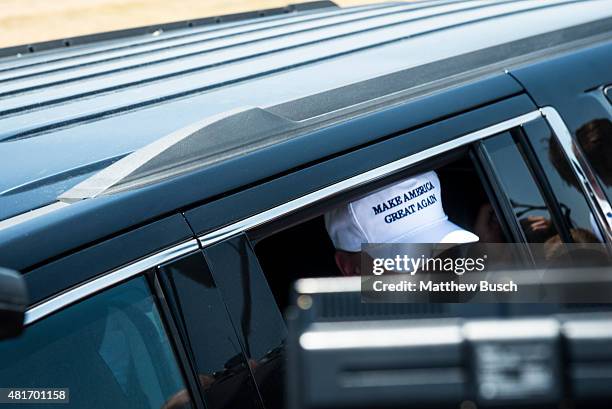 Republican Presidential candidate and business mogul Donald Trump exits his car wearing a, "Make America Great Again," hat during his trip to the...