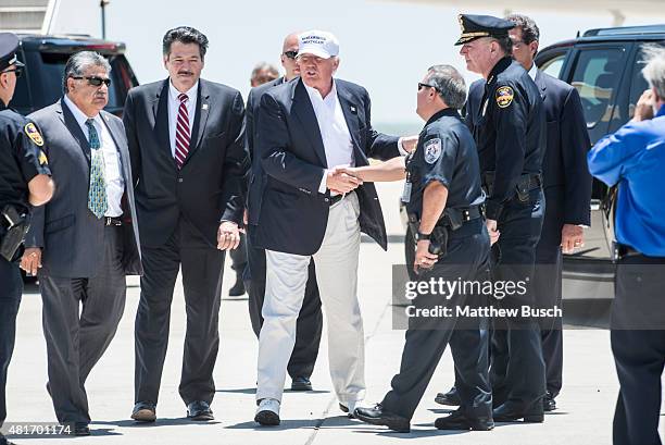 Republican Presidential candidate and business mogul Donald Trump shakes hands with local police during his trip to the border on July 23, 2015 in...