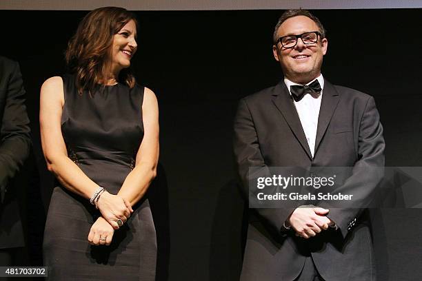 David Ellison, Dana Goldberg and producer Bryan Burk stand on stage during the world premiere of 'Mission: Impossible - Rogue Nation' at the Opera...