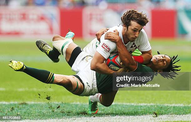 Dan Bibby of England is tackled by Justin Geduld of South Africa during the Cup quarter-final match between England and South Africa on day three of...