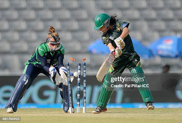 Javeria Khan of Pakistan is bowled out by Isobel Joyce captain of Ireland during the ICC Women's World Twenty20 match between Pakistan Women and...