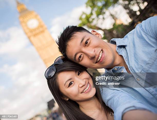 asian tourists in london taking a selfie - honeymoon europe stock pictures, royalty-free photos & images