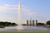 Lake with Fountain and Silos in the Background