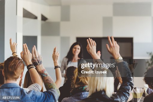 Student voting on seminar, raising hands Student voting on seminar, raising hands