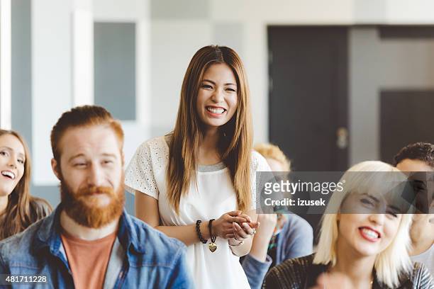 seminar for students, focus on smiling asian woman - crowd laughing stock pictures, royalty-free photos & images