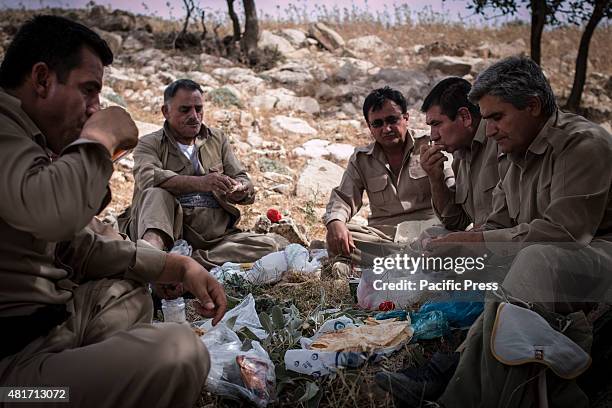Peshmergas taking a meal break. Peshmergas were trained on the mountains for survival and endurance, to prepare themselves for war.