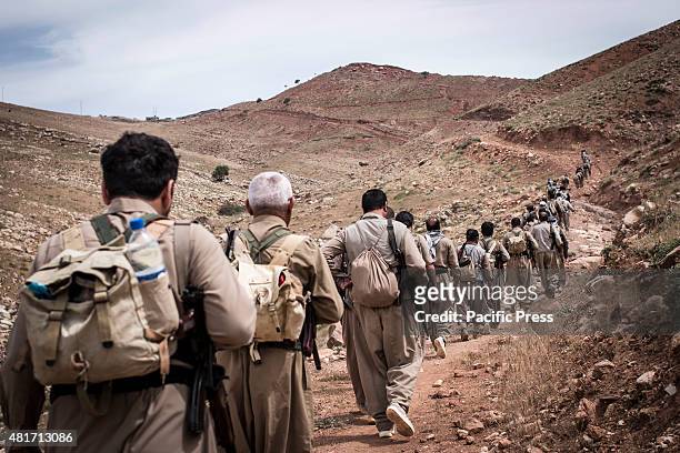Peshmergas are walking on the mountain trail. Peshmergas were trained on the mountains for survival and endurance, to prepare themselves for war.