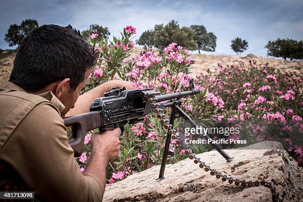 Peshmerga testing his weapon during his training. Peshmergas were trained on the mountains for survival and endurance, to prepare themselves for war.