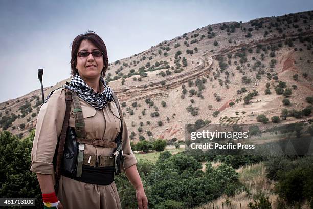 Female Kurdish Peshmerga poses on top of the mountain. Peshmergas were trained on the mountains for survival and endurance, to prepare themselves for...