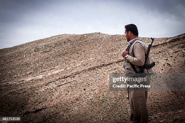 Peshmerga contemplating on top of the mountain. Peshmergas were trained on the mountains for survival and endurance, to prepare themselves for war.