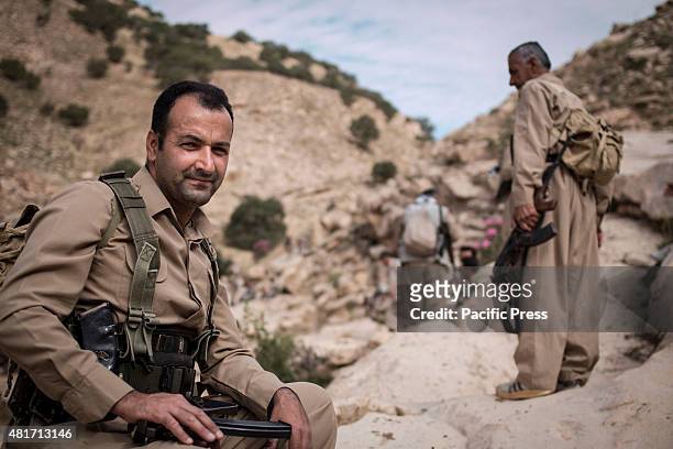 Peshmerga holds his weapon while at rest. Peshmergas were trained on the mountains for survival and endurance, to prepare themselves for war.