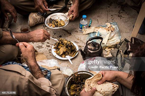 The Peshmergas share a meal after the test day. Peshmergas were trained on the mountains for survival and endurance, to prepare themselves for war.