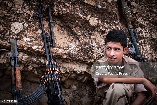 The newly recruited peshmerga rests after his test day. Peshmergas were trained on the mountains for survival and endurance, to prepare themselves...