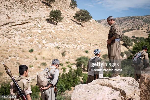 The Team Leader watching his men as they march through the mountain. Peshmergas were trained on the mountains for survival and endurance, to prepare...