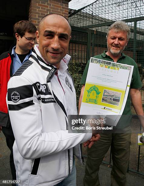 Super middleweight world champion Arthur Abraham adopts Shiva, a baby persian leopard, at Berlin Zoo's Lion House on March 31, 2014 in Berlin,...