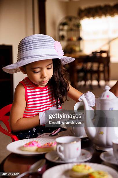 beautiful hispanic african american girl having a tea party - tea and cupcakes bildbanksfoton och bilder