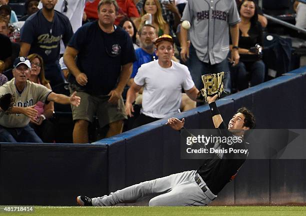 Christian Yelich of the Miami Marlins makes a sliding catch on a foul ball hit by Abraham Almonte of the San Diego Padres during the third inning of...