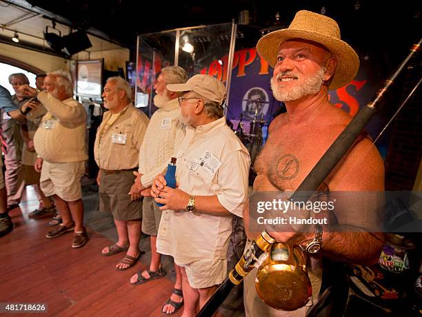 In this handout photo provided by the Florida Keys News Bureau, a bare-chested John Auvil, right, tries to impress the judges during the "Papa"...