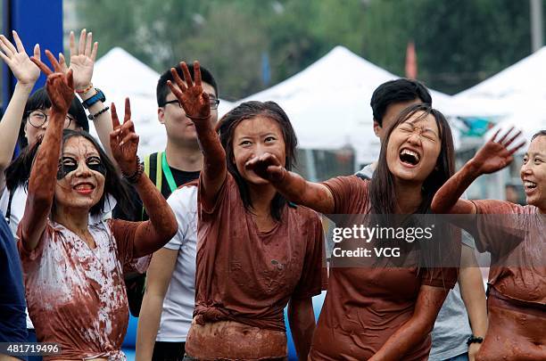 Players wave hands during a game of 2015 Swamp Soccer China at Yuetan gymnasium on July 23, 2015 in Beijing, China. Thirty-two teams take part in...