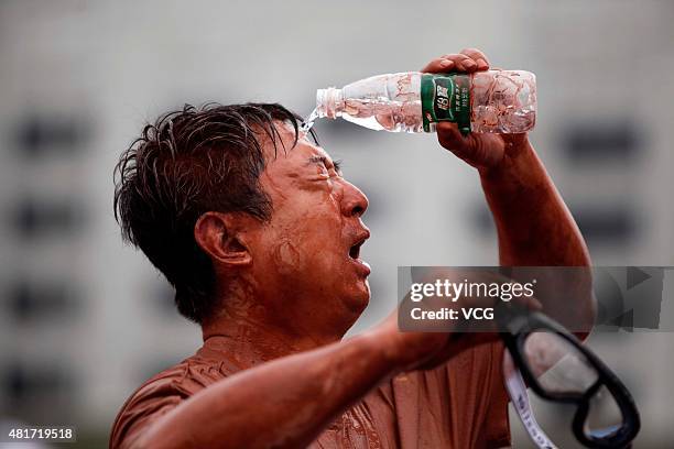 Player pours water on face during a game of 2015 Swamp Soccer China at Yuetan gymnasium on July 23, 2015 in Beijing, China. Thirty-two teams take...