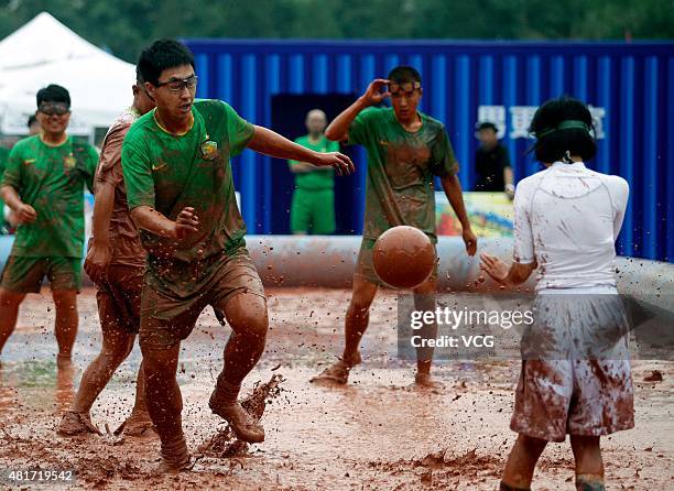 Players compete for the ball during a game of 2015 Swamp Soccer China at Yuetan gymnasium on July 23, 2015 in Beijing, China. Thirty-two teams take...