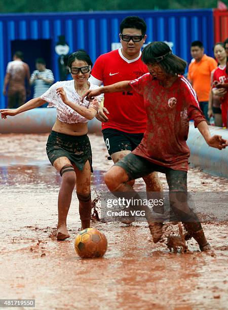 Players compete for the ball during a game of 2015 Swamp Soccer China at Yuetan gymnasium on July 23, 2015 in Beijing, China. Thirty-two teams take...