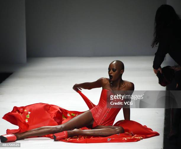 Model falls over on the runway at SECCRY Hu Sheguang Collection 2014 Show during Mercedes-Benz China Fashion Week Autumn/Winter 2014/2015 at the...