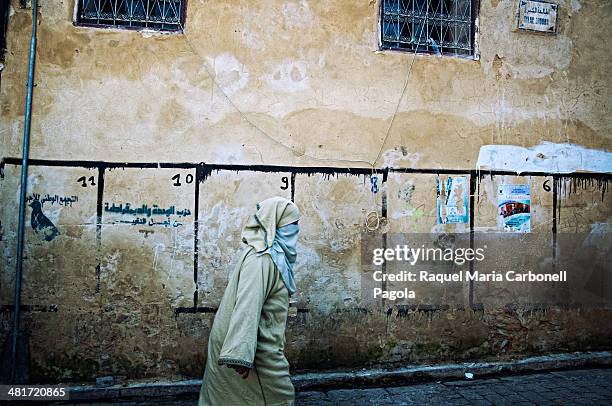 Woman walking by the medina streets.