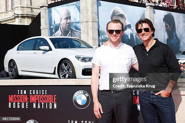 Simon Pegg and Tom Cruise attend the world premiere of 'Mission: Impossible - Rogue Nation' at the Opera House on July 23, 2015 in Vienna, Austria.