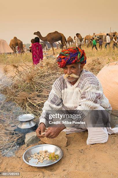 rajasthani man preparing food, india - sand art in india stock-fotos und bilder