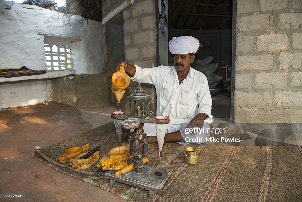 Rajasthani man making opium drink, India