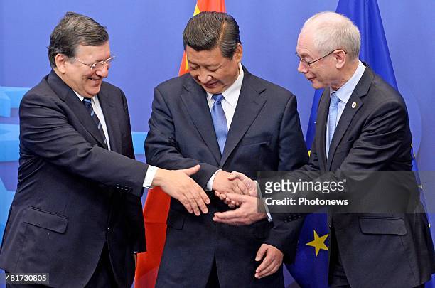 Chinese President Xi Jinping poses with President of the European Council Herman Van Rompuy and President of the European Commission Jose-Manuel...