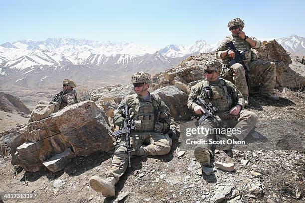 Soldiers with the U.S. Army's 2nd Battalion 87th Infantry Regiment, 3rd Brigade Combat Team, 10th Mountain Division rest along a ridgeline following...