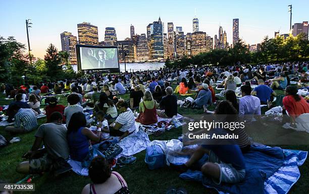 People watch an outdoor screening of the film 'Attack the Block' at Brooklyn Bridge Park on July 23, 2015 in New York City, New York.