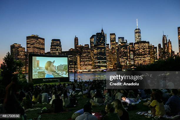 People watch an outdoor screening of the film 'Attack the Block' at Brooklyn Bridge Park on July 23, 2015 in New York City, New York.