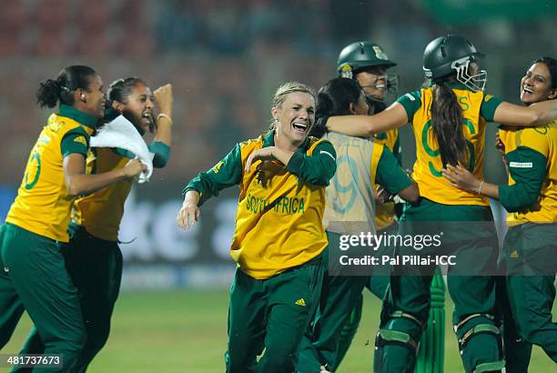 Mignon Du Preez captain of South Africa celebrates with teammates after winning the ICC Women's World Twenty20 match between New Zealand Women and...