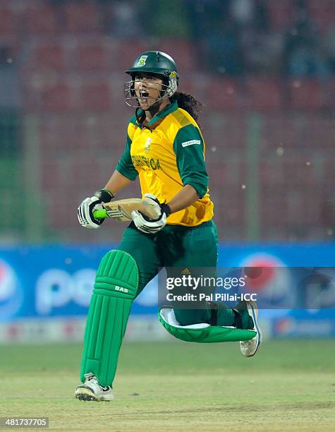 Chloe Tryon of South Africa runs to celebrate after hitting the winning run during the ICC Women's World Twenty20 match between New Zealand Women and...