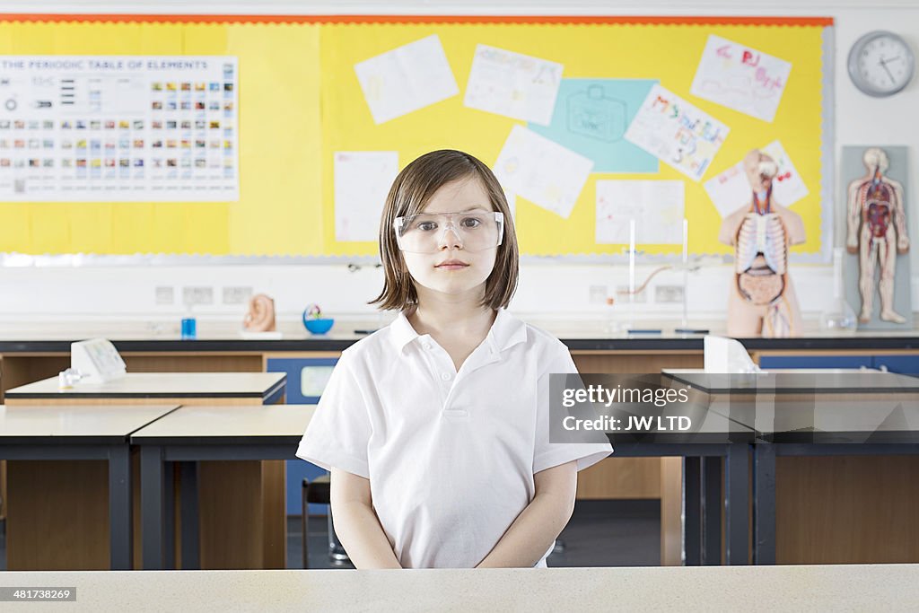 Girl (11-13) standing in school laboratory