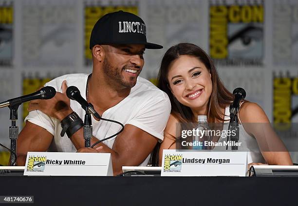 Actor Ricky Whittle and actress Lindsey Morgan attend a special video presentation and panel for "The 100" during Comic-Con International 2015 at the...