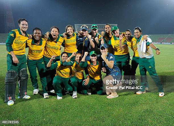 Team South Africa poses for a team photo as they celebrate after winning the ICC Women's World Twenty20 match between New Zealand Women and South...